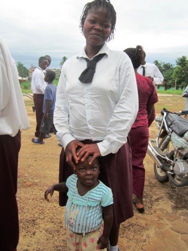 Jestina is as proud of her little girl as she is of her studies.