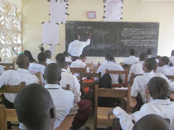 Saye solves a log problem and gets props from his classmates.